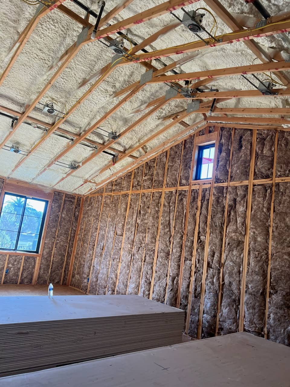 image of a completed building insulation install with sprayfoam ceilings and fiberglass walls
