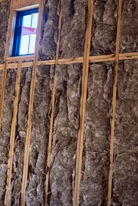 installed fiberglass insulation on a wall
